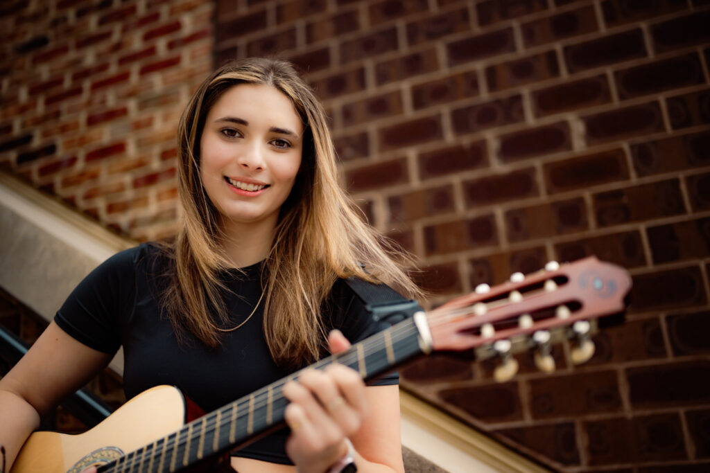high school senior playing guitar during senior session