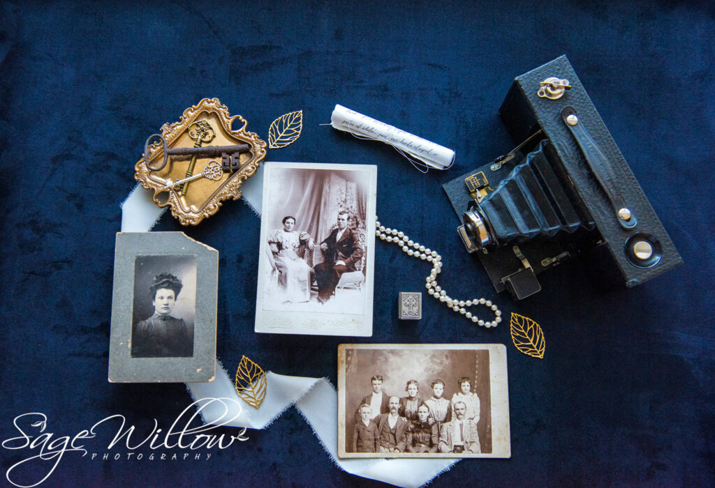 flat lay photo of an old camera and some old photographs