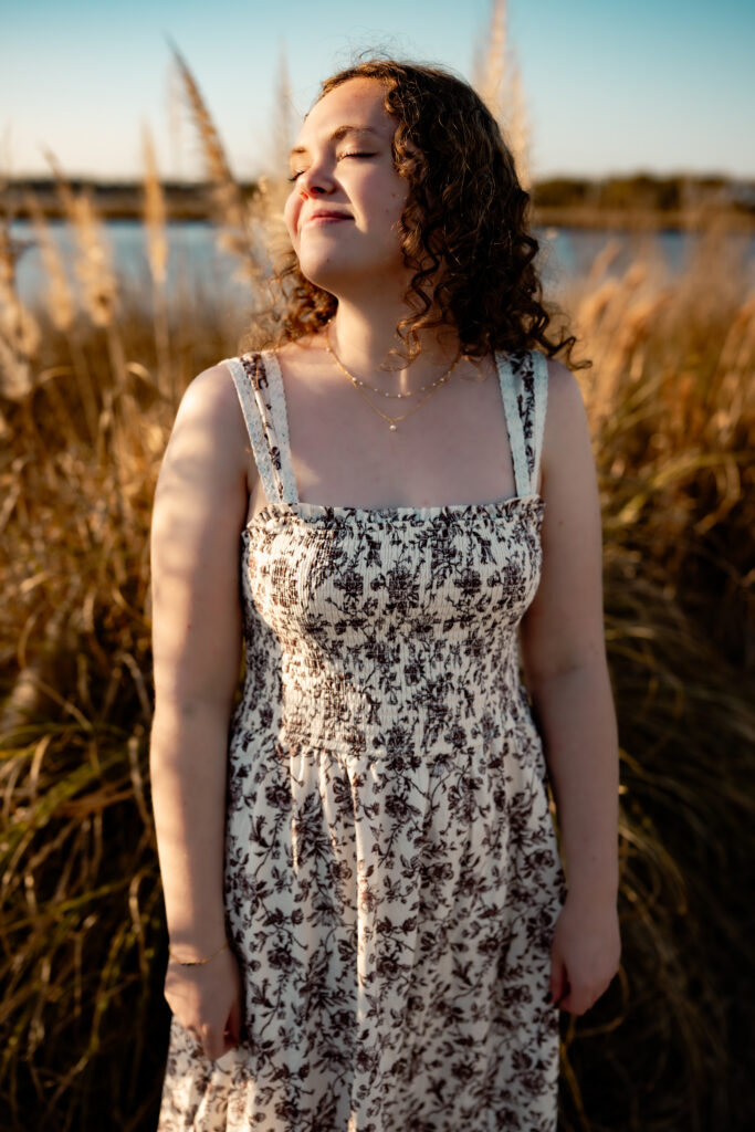 color photo of a girl taking in the warm sun at the beach on Topsail Island, NC