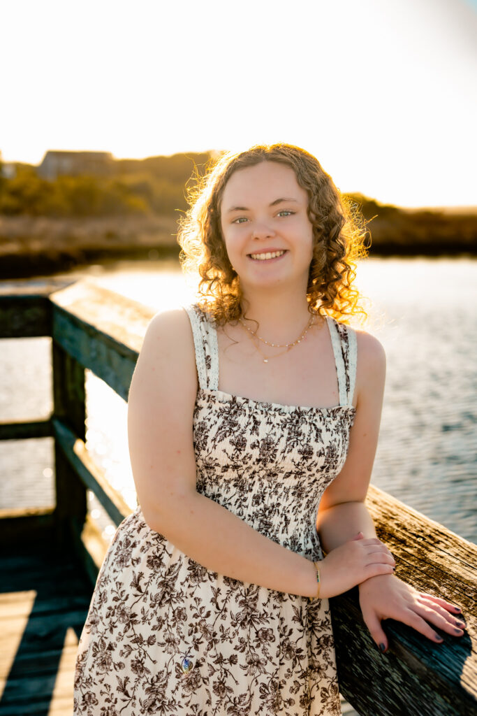 color photo of a girl standing in the sun on a dock at Topsail Island, NC