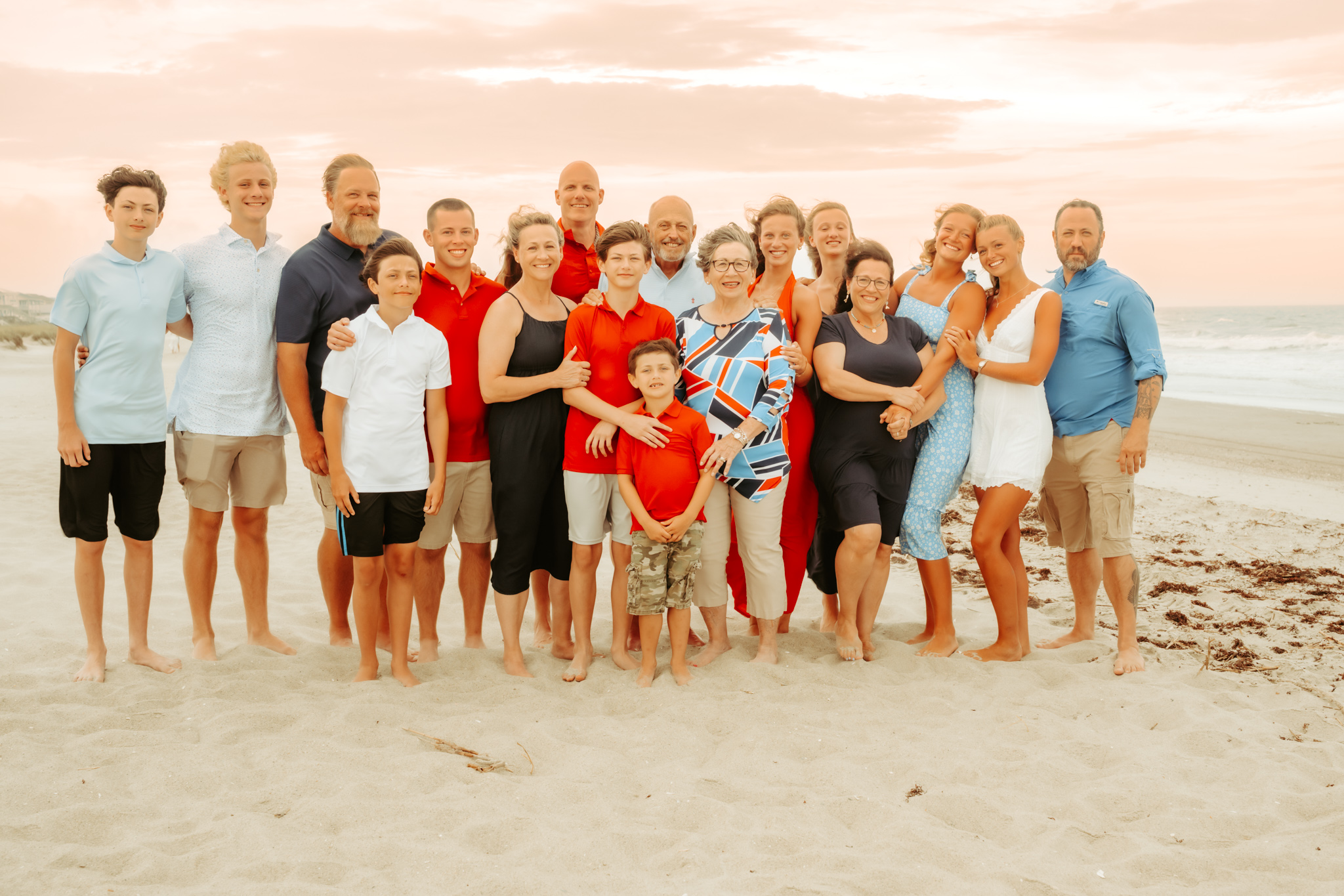 extended family photograph taken on a beach at sunset