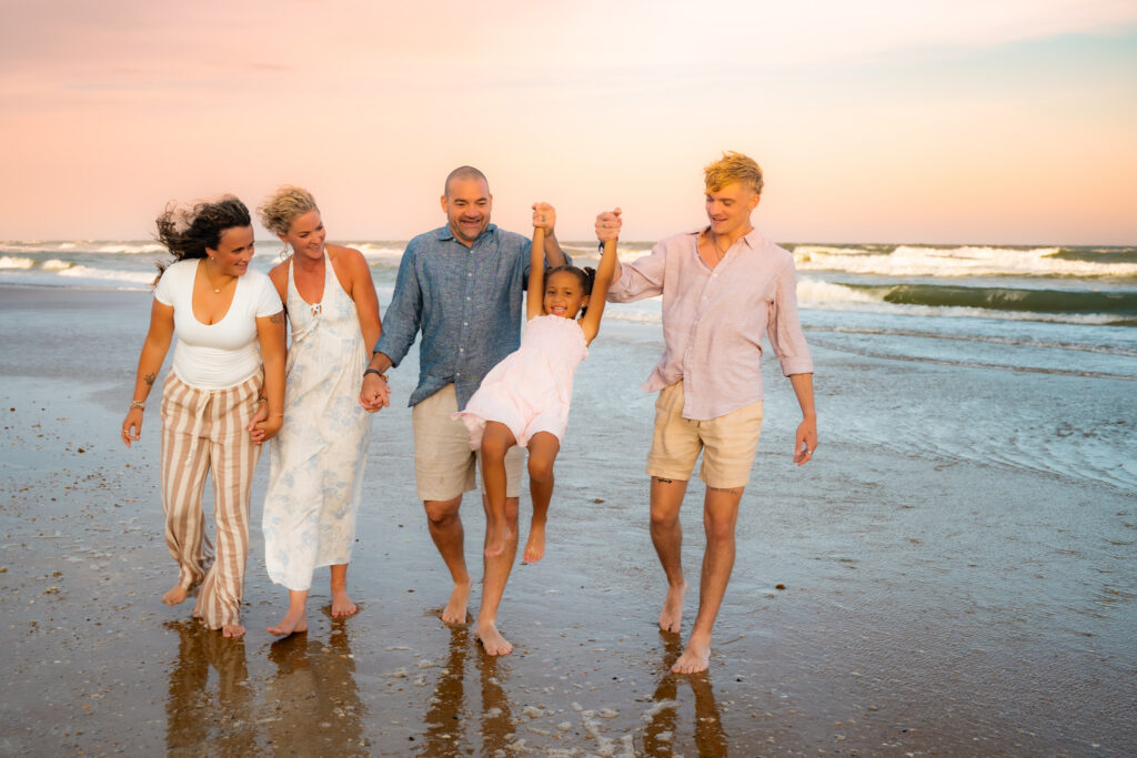 Color family photo on the beach walking with each other