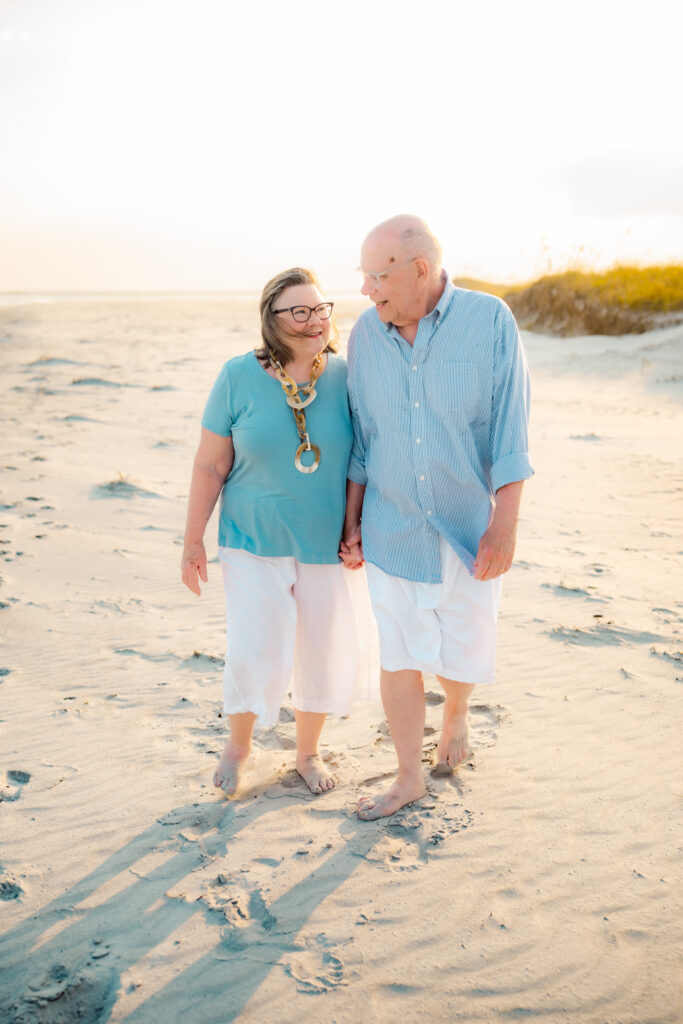 color photo of a couple walking on beach