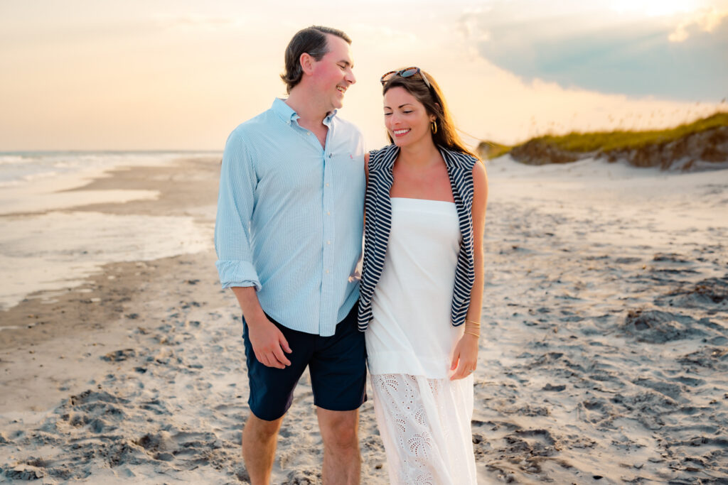color photo of a couple walking on the beach