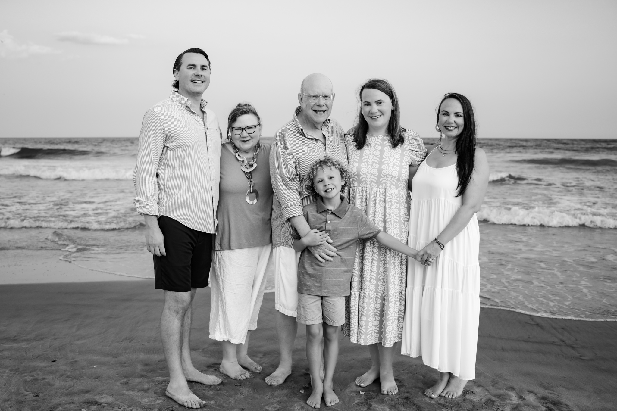 black and white family photo on the beach