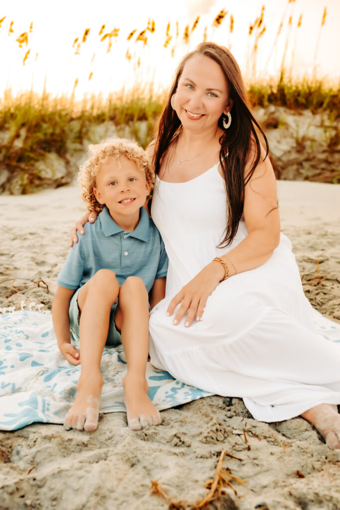 color photo on beach of mom and son