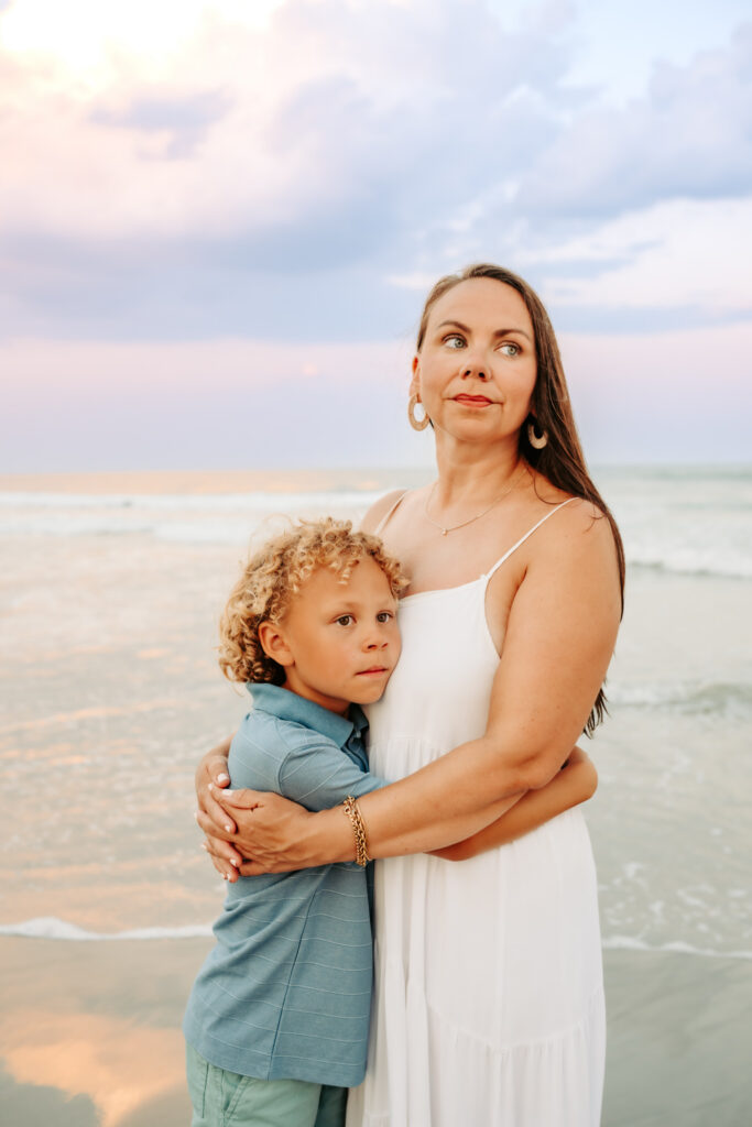 color photo of mom and son on the beach