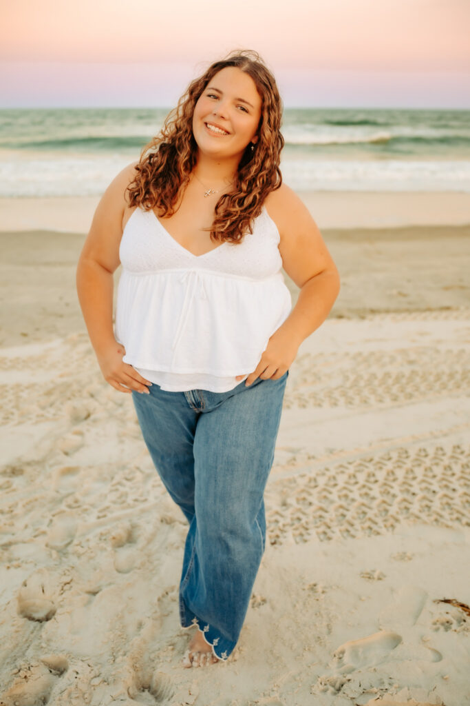 one girl walking on the beach smiling