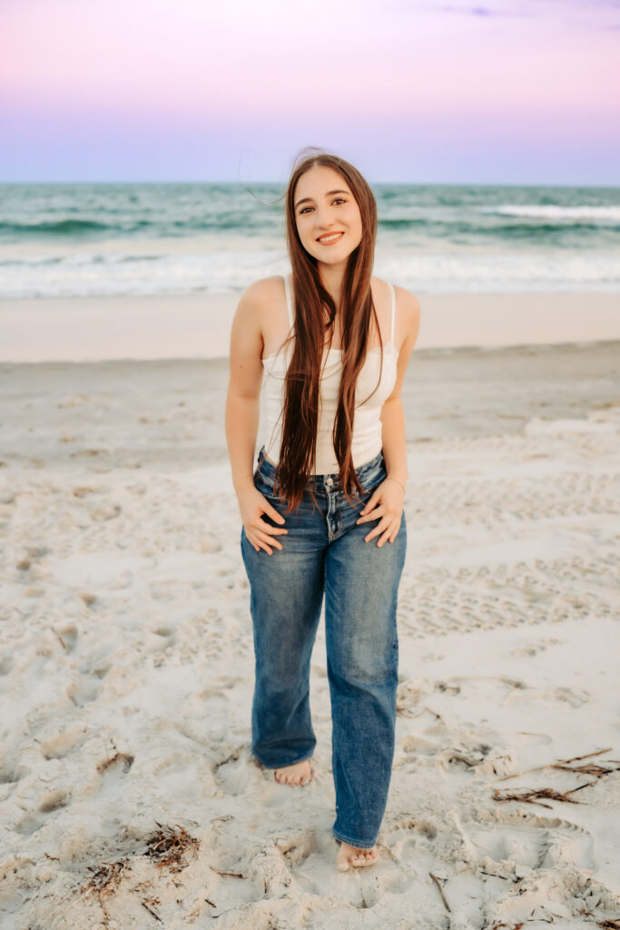 One girl walking on the beach smiling