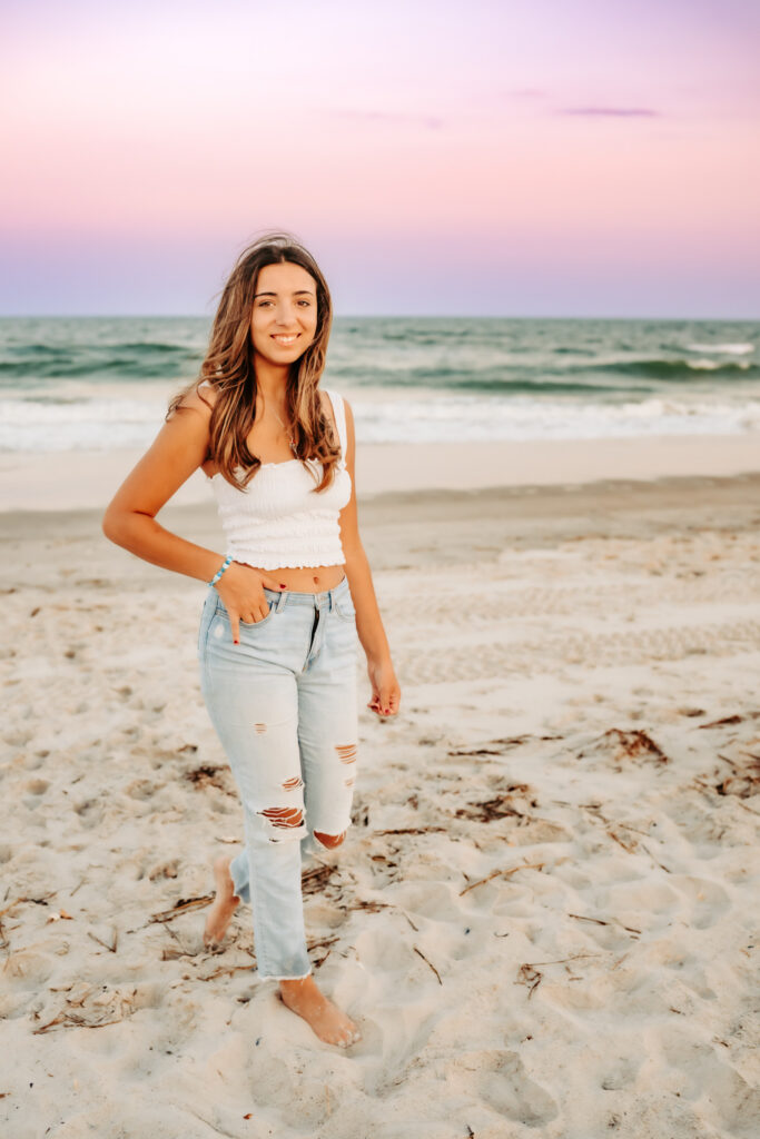 One girl walking on the beach smiling