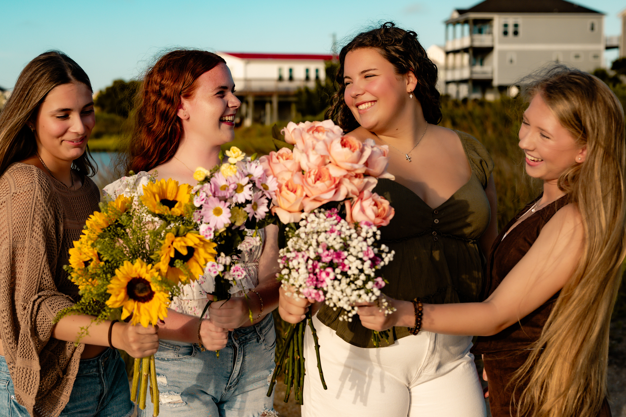 Girls in the sun with flowers smiling