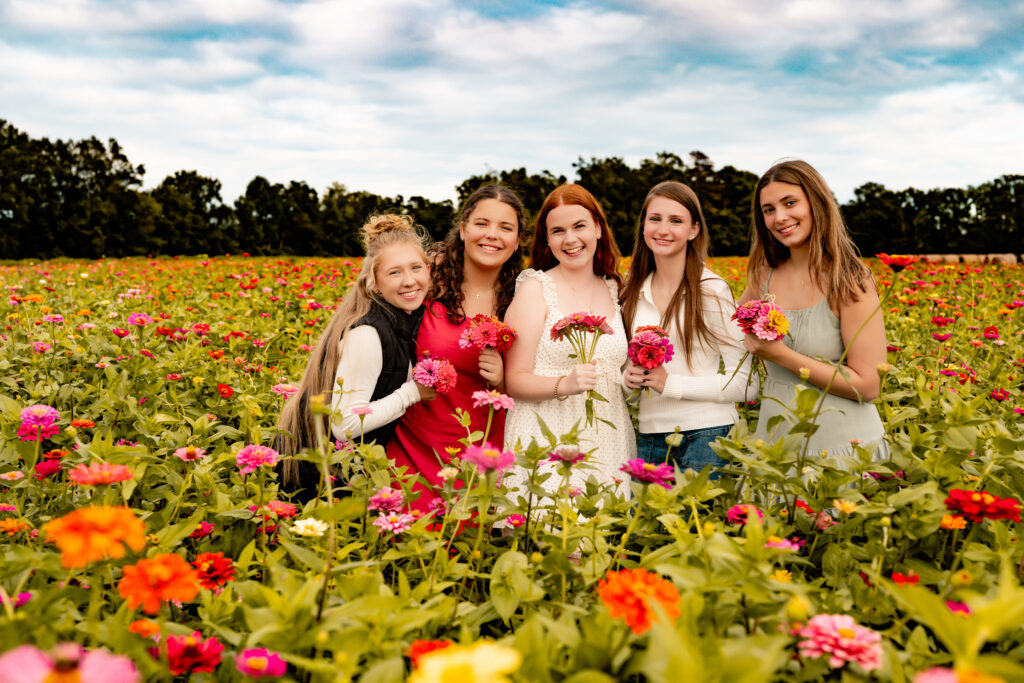 group photo of girls standing in a flower field