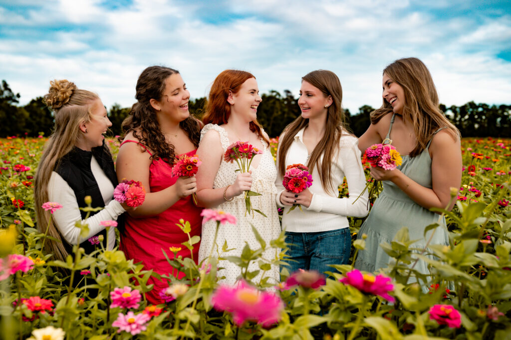 group of senior rep team girls in a flower field smiling